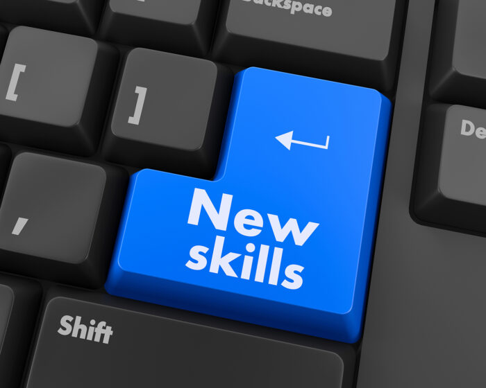 Computer keyboard with the words "New Skills" on its enter key.