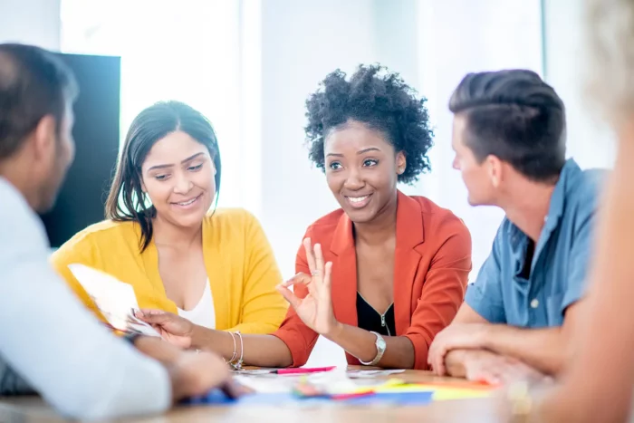 A diverse group of young adults having a discussion at a table.