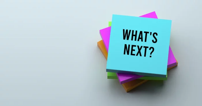 Stack of multicolored post-it notes with the words "WHAT'S NEXT?" on the top note.