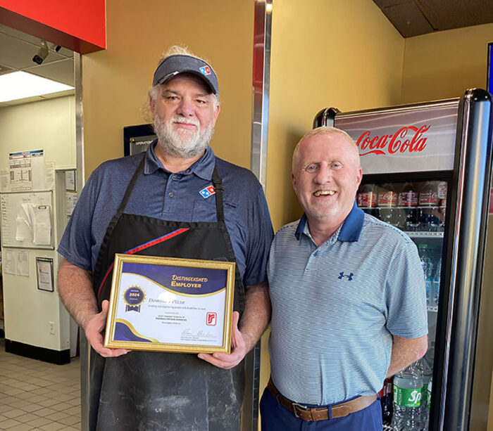 DRS presents framed certificate to Domino's Pizza representative