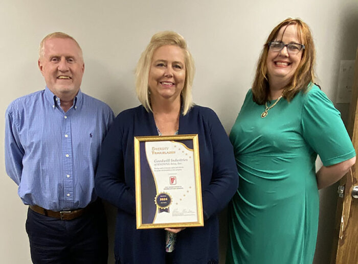 DRS presents framed certificate to Goodwill Industries representative